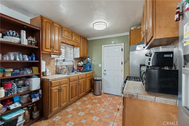 kitchen with tile countertops, ornamental molding, light tile patterned floors, and tasteful backsplash