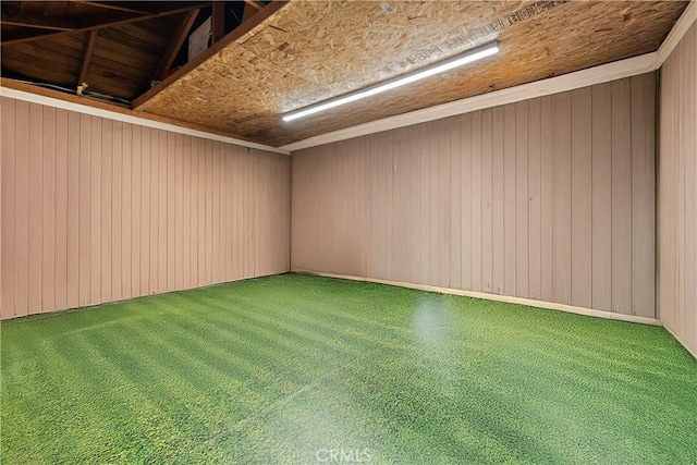 spare room with wood walls and golf simulator