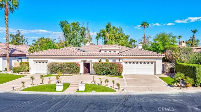 mediterranean / spanish house with a garage