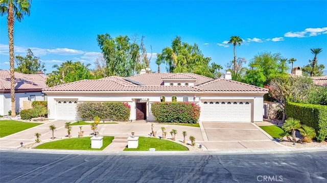 mediterranean / spanish-style home with a garage