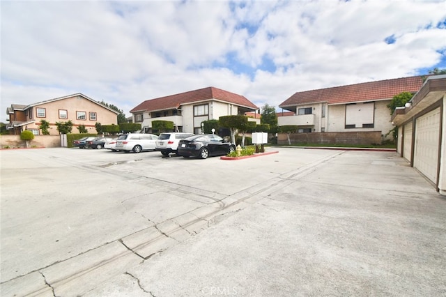 view of parking / parking lot featuring a garage