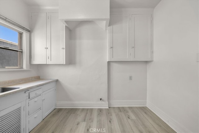 washroom with light wood-type flooring