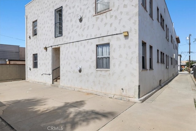 view of side of home featuring a patio area