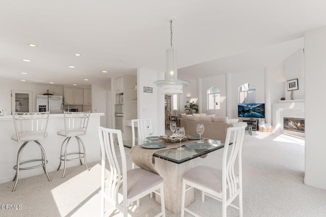 dining room featuring light carpet and sink