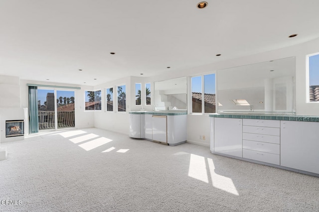 unfurnished living room featuring light colored carpet