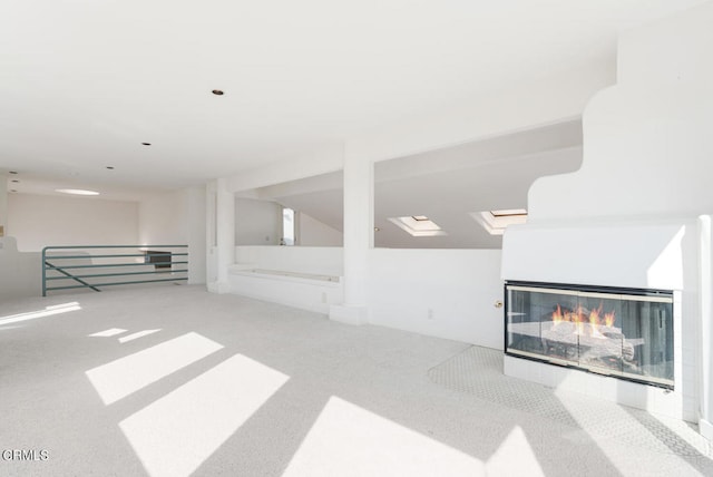 basement featuring carpet flooring and a tiled fireplace