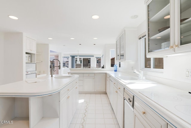 kitchen featuring sink, white cabinets, white appliances, and light tile patterned floors