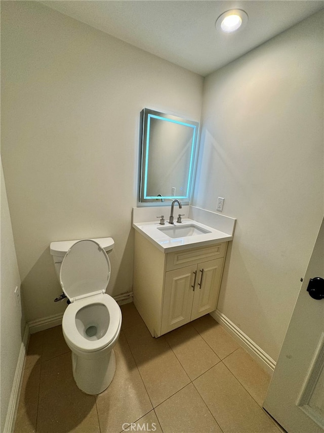 bathroom featuring tile patterned flooring, vanity, and toilet