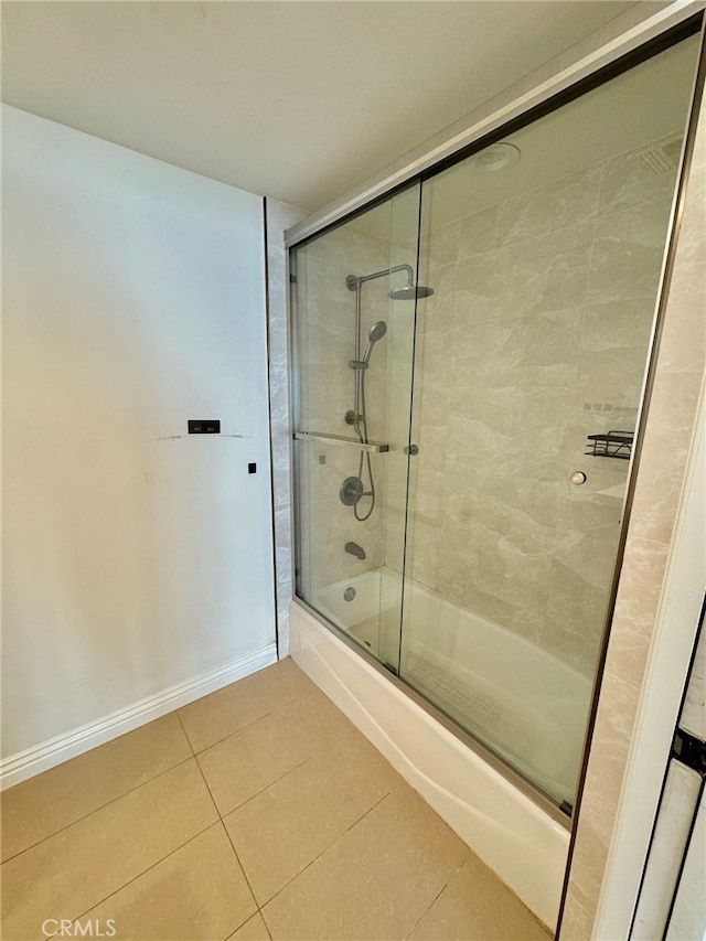 bathroom featuring tile patterned flooring and shower / bath combination with glass door