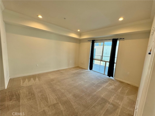 spare room with ornamental molding and light colored carpet