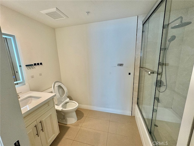 bathroom with tile patterned floors, a shower with shower door, vanity, and toilet