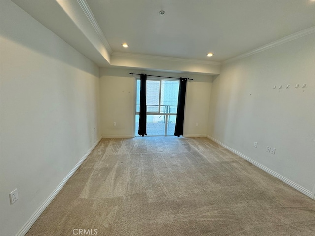 unfurnished room with ornamental molding and light colored carpet