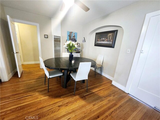 dining space with ceiling fan and hardwood / wood-style flooring