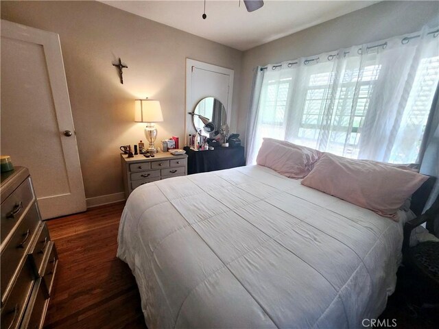 bedroom with dark hardwood / wood-style floors