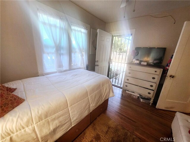 bedroom with dark hardwood / wood-style flooring