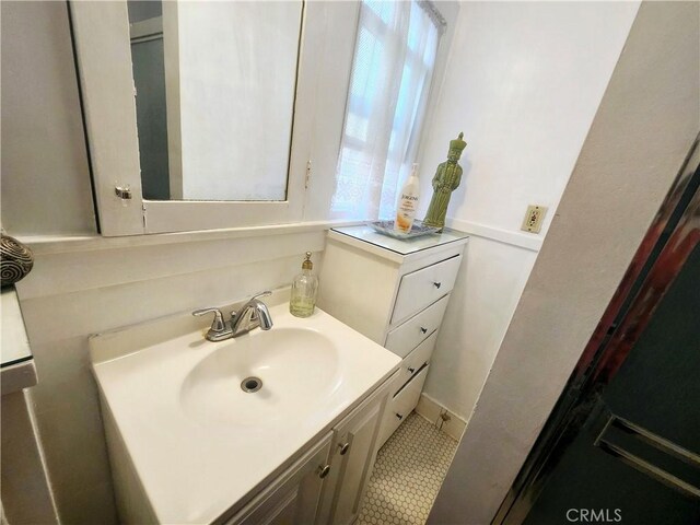 bathroom with tile patterned flooring and vanity