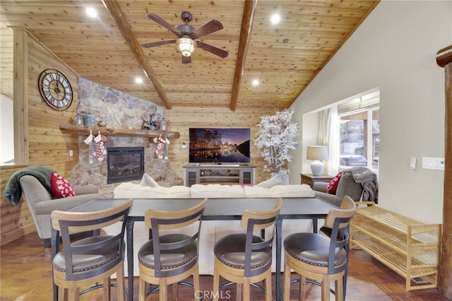 interior space featuring beamed ceiling, a kitchen bar, wooden ceiling, and dark wood-type flooring