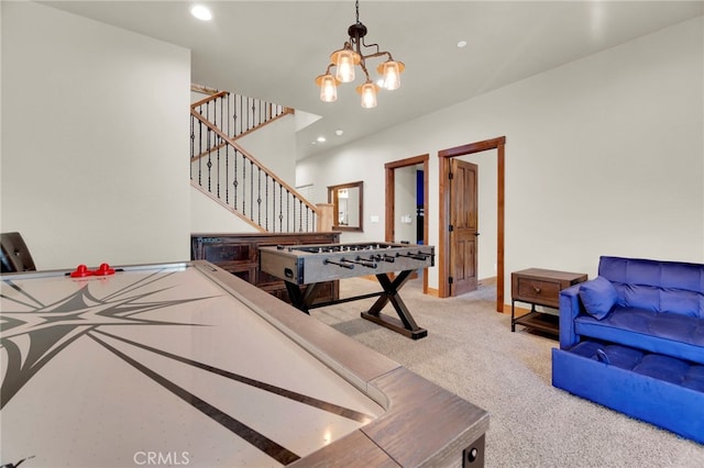 recreation room with light colored carpet and an inviting chandelier