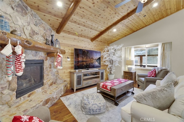 living room with wooden ceiling, high vaulted ceiling, hardwood / wood-style flooring, a fireplace, and beam ceiling