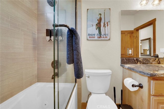 bathroom featuring shower / bath combination with glass door and toilet