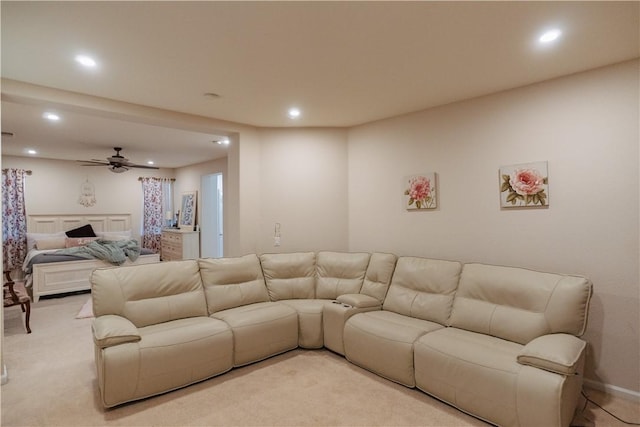 living room with ceiling fan and light colored carpet