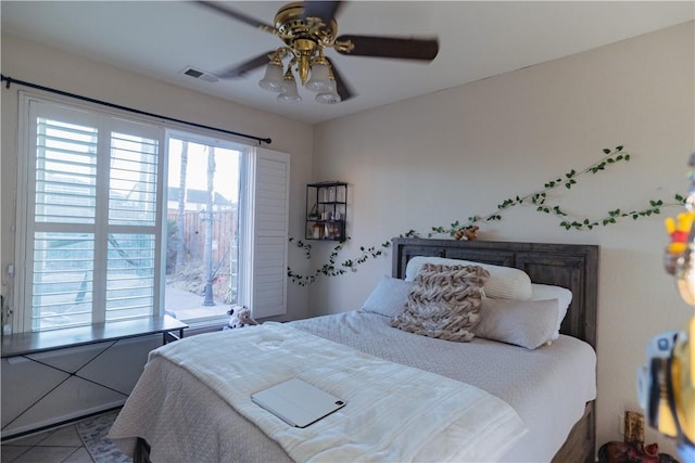 tiled bedroom featuring ceiling fan