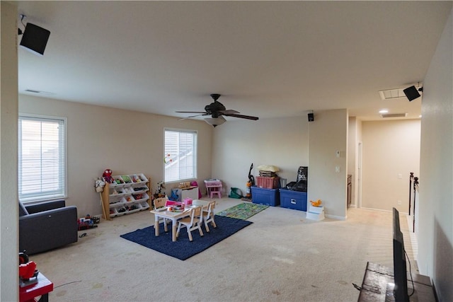 rec room with carpet, ceiling fan, and a healthy amount of sunlight