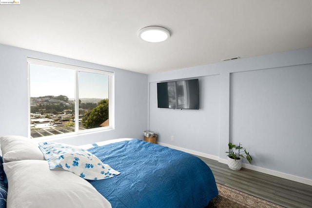 bedroom with dark wood-type flooring