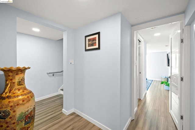 corridor with hardwood / wood-style floors