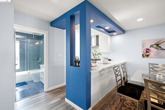 interior space with wood-type flooring and white cabinets