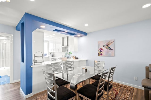 dining space with hardwood / wood-style floors