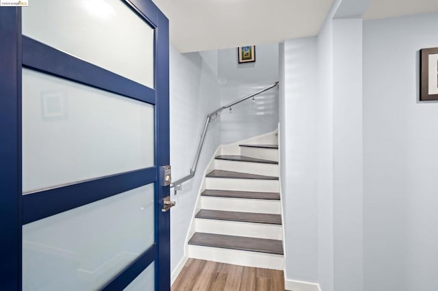 stairs featuring wood-type flooring