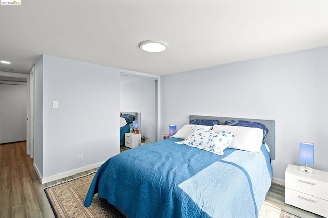 bedroom with a closet and light wood-type flooring