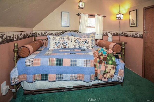 carpeted bedroom with lofted ceiling