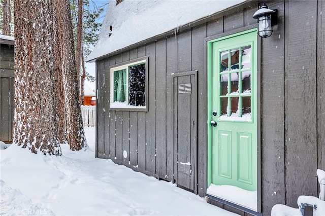 view of snow covered property entrance