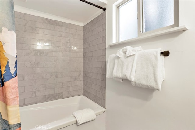 bathroom with crown molding and shower / bath combo