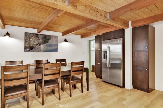 dining space with beam ceiling, light hardwood / wood-style floors, and wooden ceiling