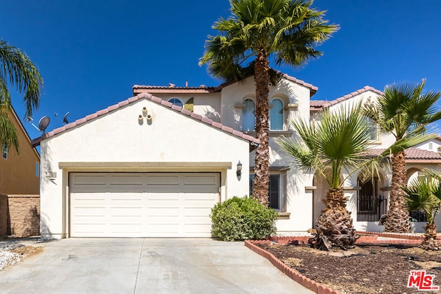 mediterranean / spanish-style house with a garage