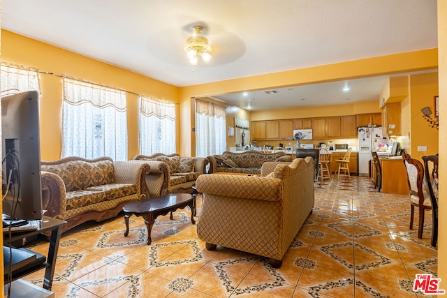 living room featuring light tile patterned flooring and ceiling fan