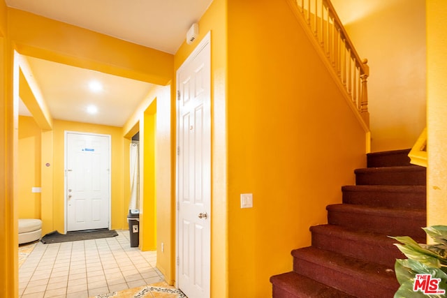 staircase with tile patterned floors