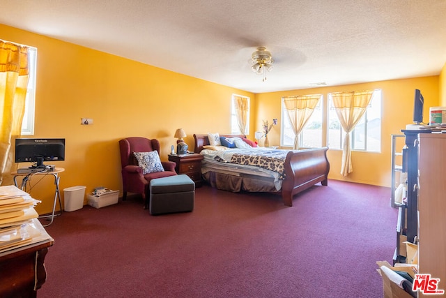 carpeted bedroom with a textured ceiling and ceiling fan