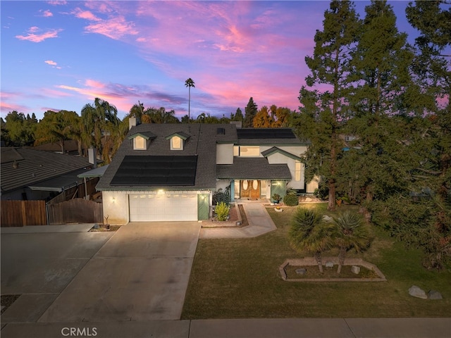 7204 Arleta Ave, Bakersfield, CA 93308 - view of front facade featuring solar panels, a garage, and a lawn