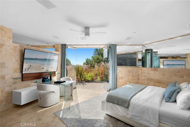 bedroom with expansive windows and light tile patterned flooring