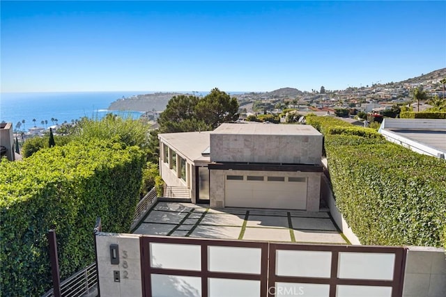 exterior space with a garage and a water view