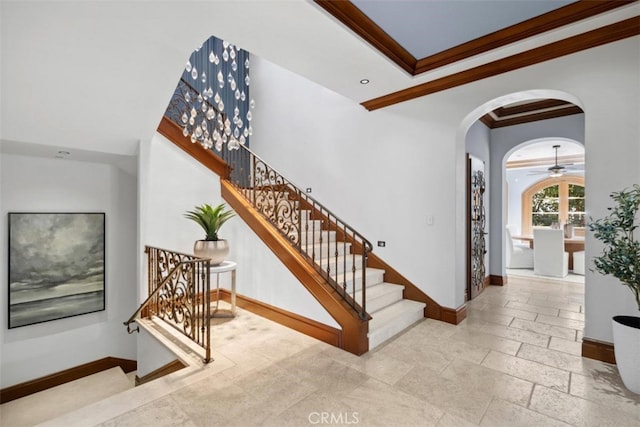 staircase featuring ornamental molding