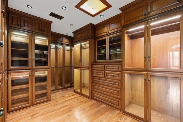 walk in closet featuring light hardwood / wood-style flooring