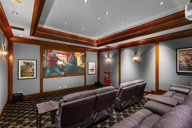 carpeted cinema with crown molding and a tray ceiling