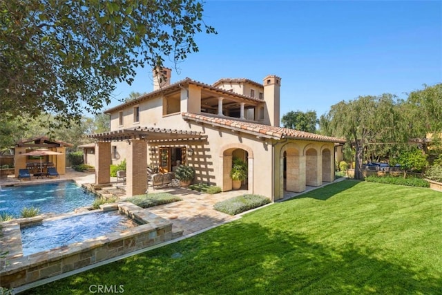 rear view of property featuring a patio area, a yard, and a pergola