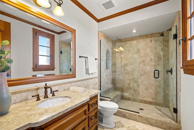 bathroom featuring vanity, crown molding, toilet, and walk in shower