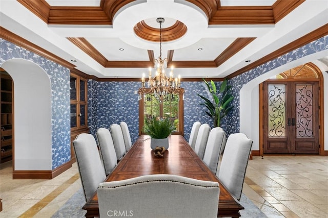 dining area with coffered ceiling, french doors, crown molding, and an inviting chandelier